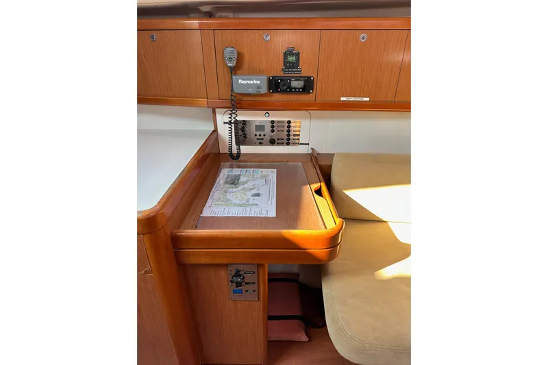 Shamrock Yacht Photos Pics Navigation station in 2011 Beneteau Oceanis 40 yacht with chart and communication equipment.