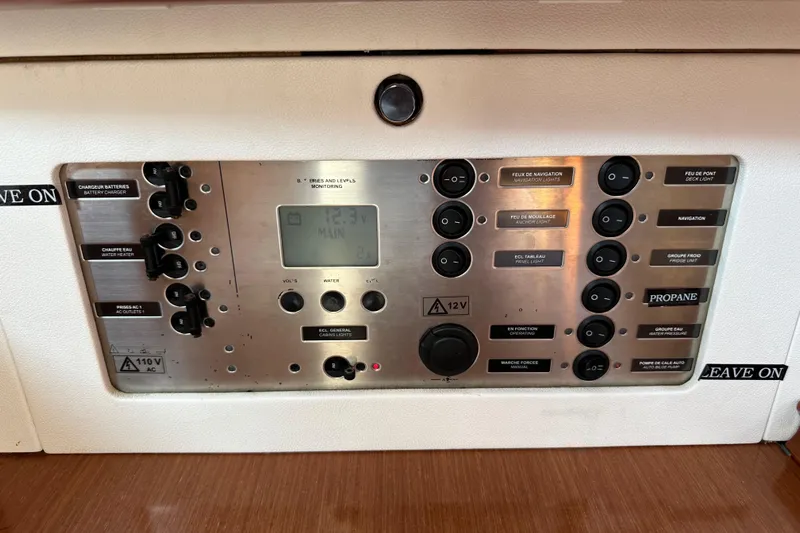 Shamrock Yacht Photos Pics Control panel of a 2011 Beneteau Oceanis 40 sailboat, featuring various switches and indicators.