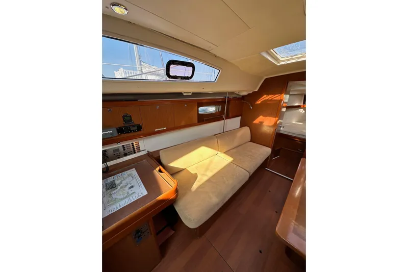 Shamrock Yacht Photos Pics Interior of 2011 Beneteau Oceanis 40 sailboat with cozy seating and navigation area.