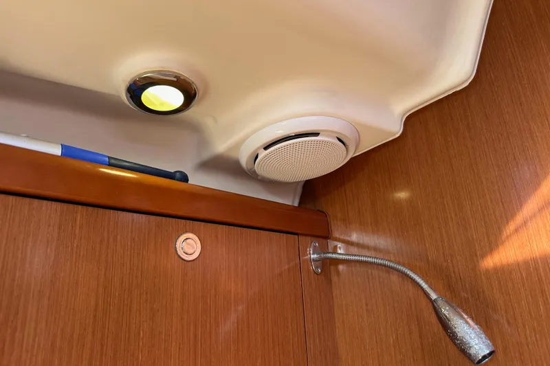 Shamrock Yacht Photos Pics Interior of 2011 Beneteau Oceanis 40 yacht with light, speaker, and wood paneling.