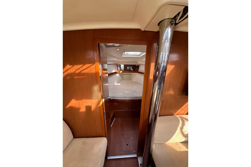 Shamrock Yacht Photos Pics Interior of 2011 Beneteau Oceanis 40 sailboat, featuring cozy cabin and wooden finishes.