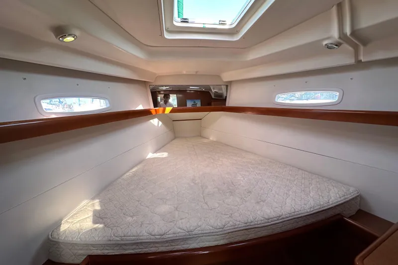 Shamrock Yacht Photos Pics Interior cabin of 2011 Beneteau Oceanis 40 sailboat with spacious bed and natural light.