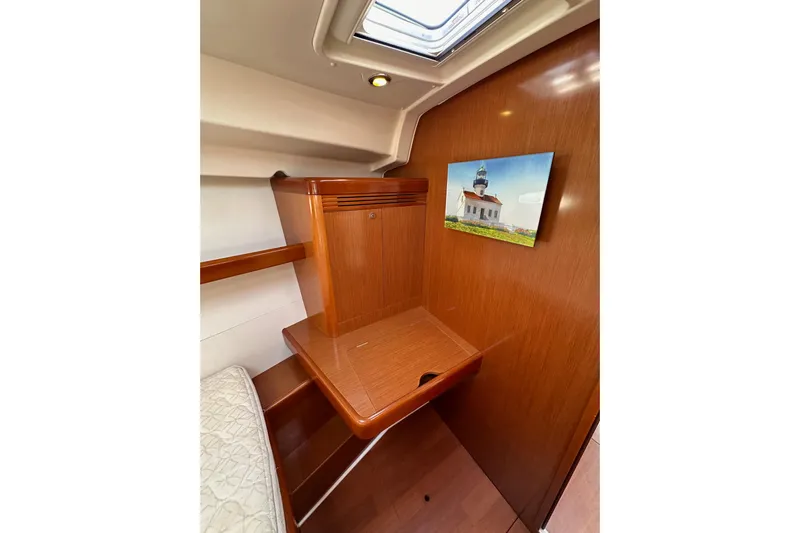 Shamrock Yacht Photos Pics Interior of 2011 Beneteau Oceanis 40 yacht with wooden desk and wall art.