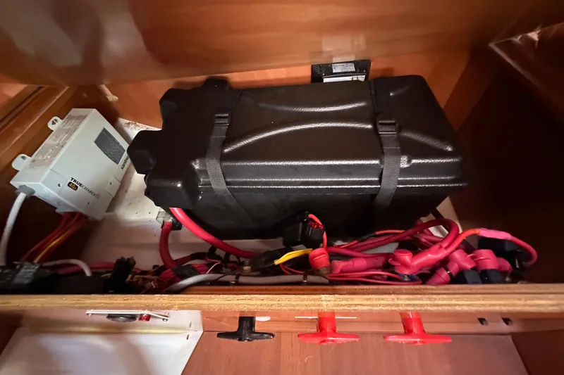Shamrock Yacht Photos Pics Battery compartment of a 2011 Beneteau Oceanis 40 sailboat with wiring and components.