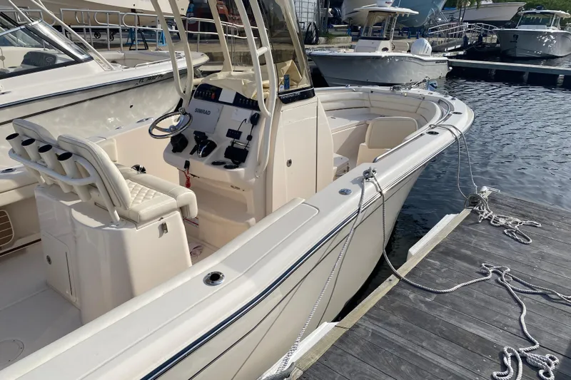  Yacht Photos Pics 2025 Grady-White Fisherman 236 boat docked, featuring a sleek design and modern controls.