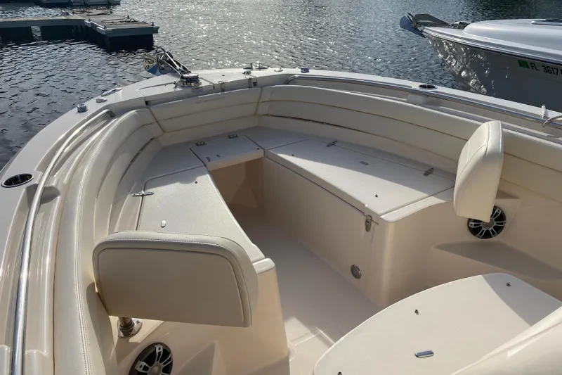  Yacht Photos Pics 2025 Grady-White Fisherman 236 boat interior with seating, docked on calm water.