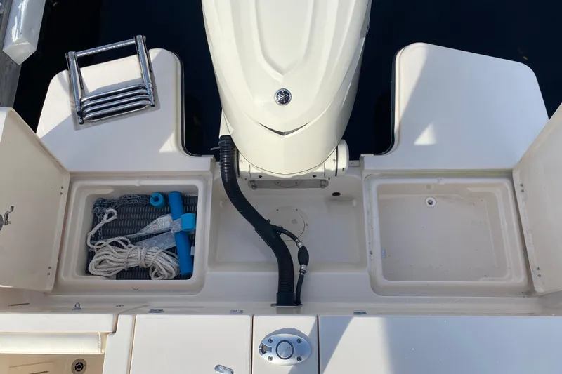  Yacht Photos Pics 2025 Grady-White Fisherman 236 boat deck with storage compartments and motor.