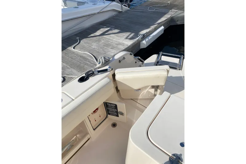  Yacht Photos Pics 2025 Grady-White Fisherman 236 boat interior near dock, featuring seating and storage.