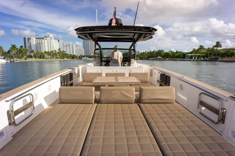 Darya One Yacht Photos Pics Luxurious 2019 Pardo Yachts P43 with spacious deck, cruising near modern waterfront buildings.