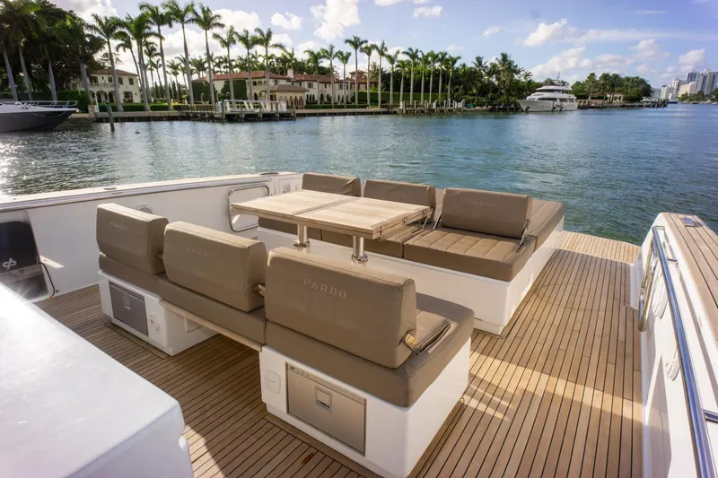 Darya One Yacht Photos Pics Luxurious 2019 Pardo Yachts P43 with elegant deck seating and scenic waterfront view.