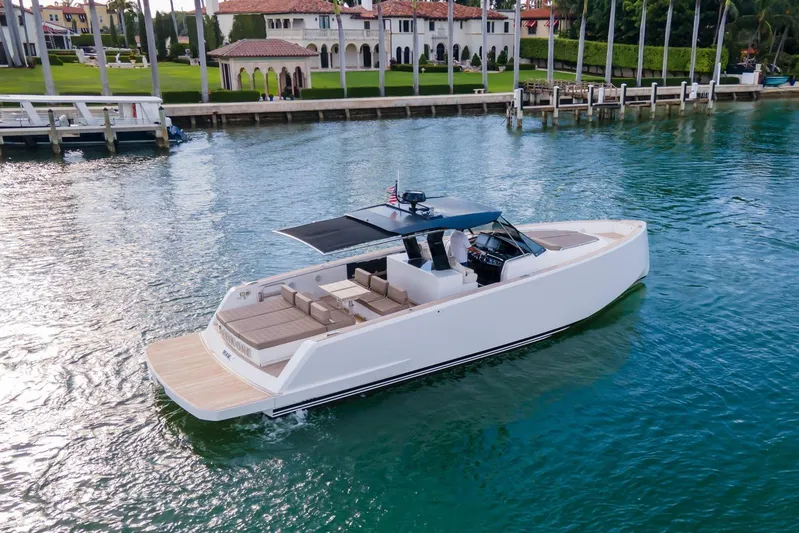 Darya One Yacht Photos Pics 2019 Pardo Yachts P43 cruising on serene waters near luxury waterfront estate.
