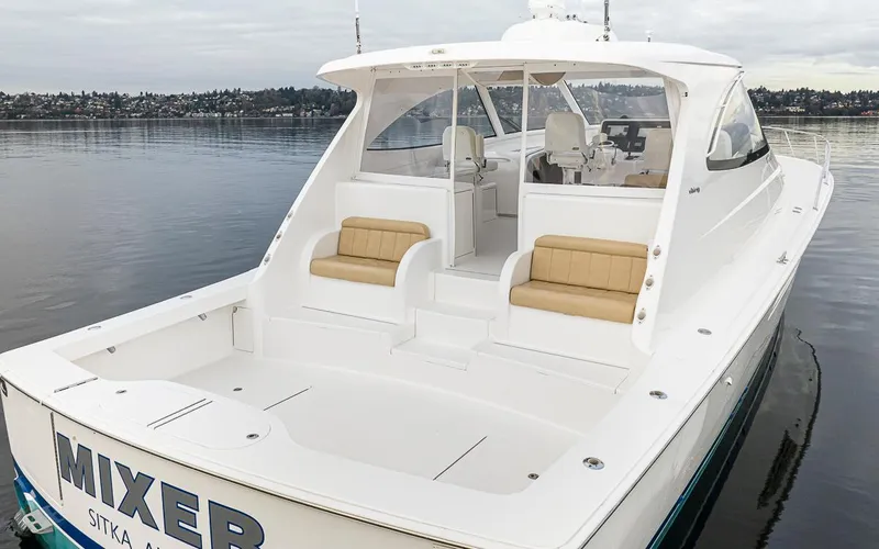 Mixer Yacht Photos Pics 2015 Viking 52 yacht with spacious deck and seating, docked on calm waters.
