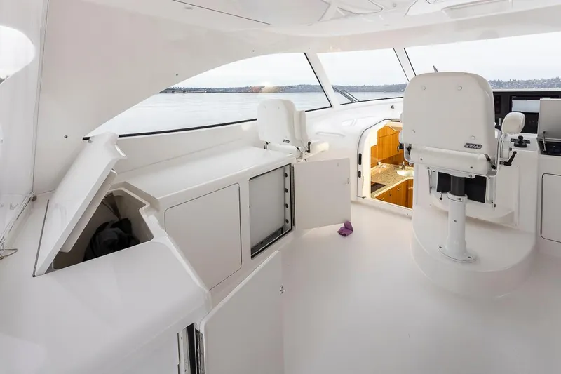 Mixer Yacht Photos Pics Interior of 2015 Viking 52 yacht with white seating and storage compartments.