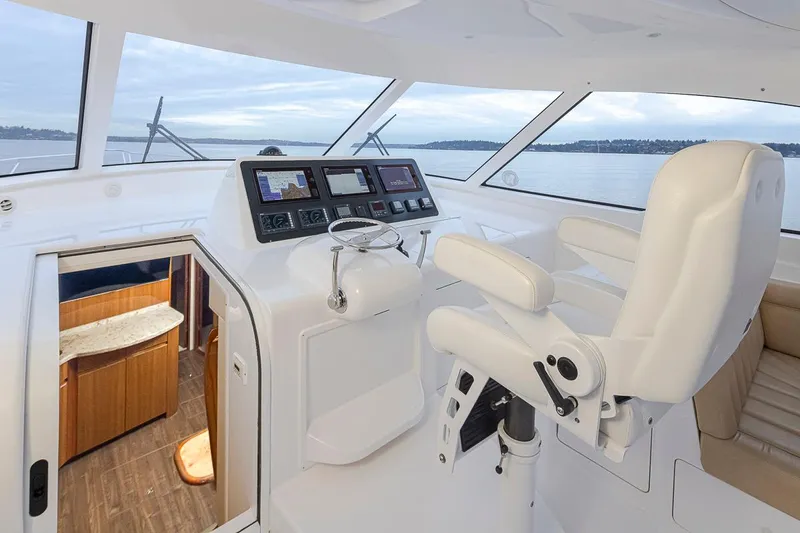 Mixer Yacht Photos Pics Helm station of 2015 Viking 52 yacht with navigation screens and captain's chair.