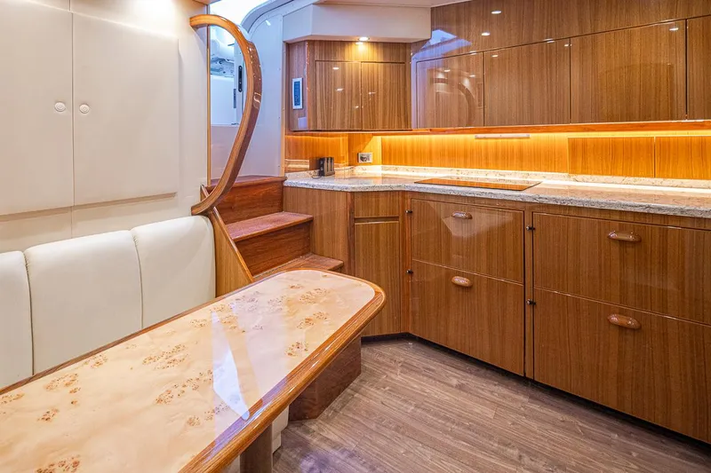 Mixer Yacht Photos Pics Luxurious interior of a 2015 Viking 52 yacht with wooden cabinetry and modern lighting.