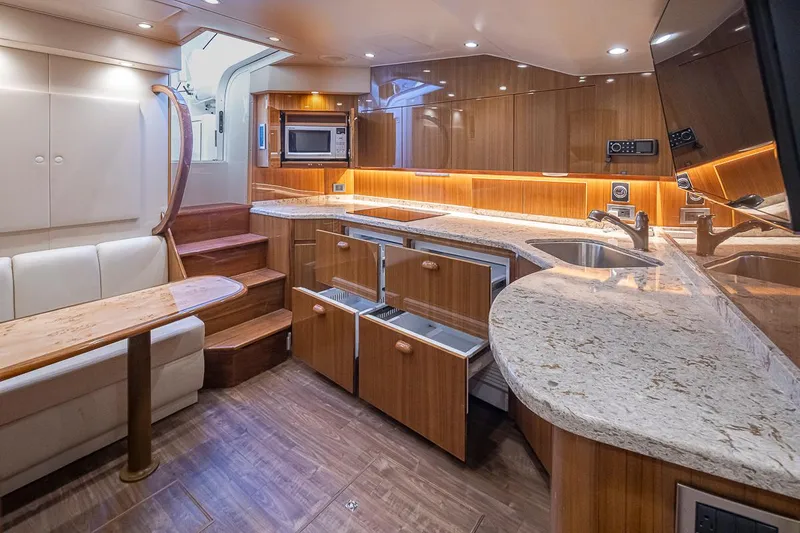 Mixer Yacht Photos Pics Luxurious interior of a 2015 Viking 52 yacht with modern kitchen and dining area.