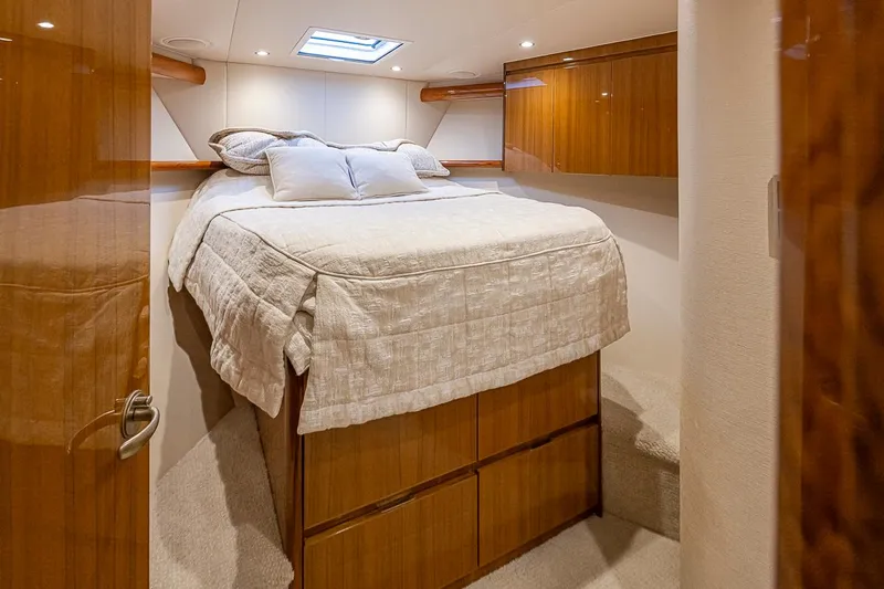 Mixer Yacht Photos Pics Luxurious bedroom interior of 2015 Viking 52 yacht with skylight and wooden cabinetry.