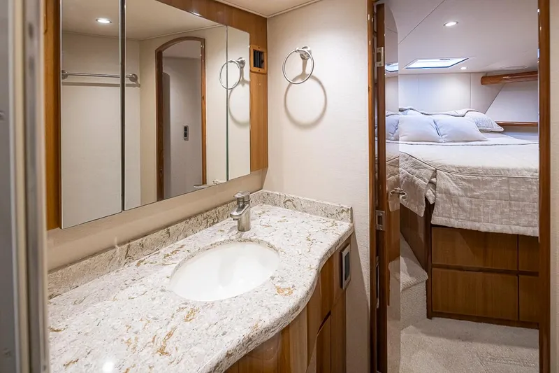 Mixer Yacht Photos Pics Luxurious bathroom and bedroom in a 2015 Viking 52 yacht with marble countertop.