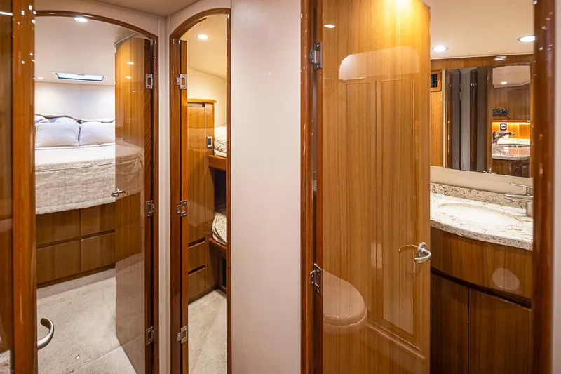 Mixer Yacht Photos Pics Luxurious interior of 2015 Viking 52 yacht with wooden finishes and cozy bedroom.