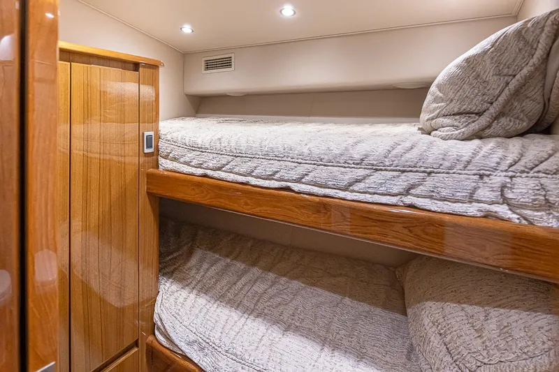 Mixer Yacht Photos Pics 2015 Viking 52 yacht interior with wooden bunk beds and cozy lighting.