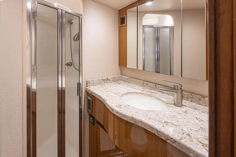Mixer Yacht Photos Pics Modern bathroom in 2015 Viking 52 yacht with marble countertop and glass shower.