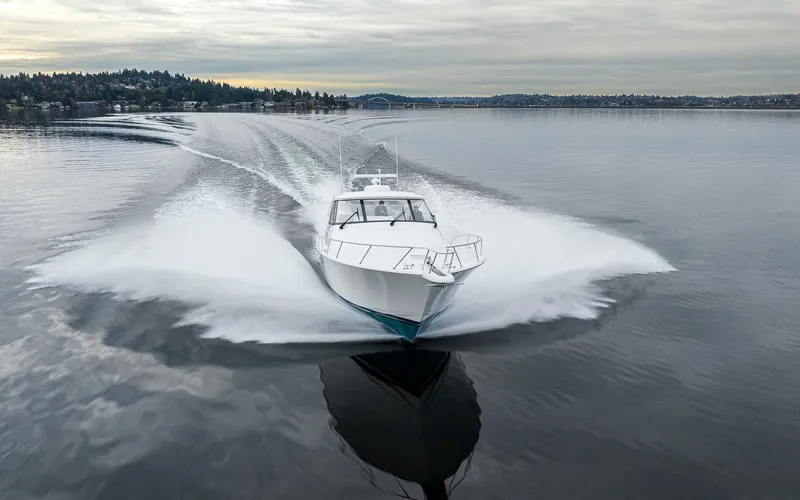 Mixer Yacht Photos Pics 2015 Viking 52 boat cruising on a calm lake with scenic background.