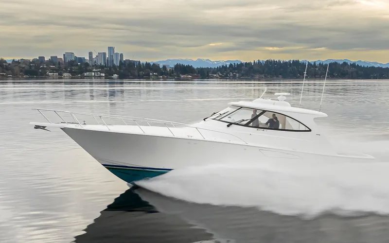 Mixer Yacht Photos Pics 2015 Viking 52 yacht cruising on calm waters with city skyline in the background.