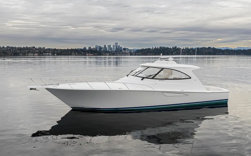 Mixer Yacht Photos Pics 2015 Viking 52 yacht on calm water with city skyline in background.