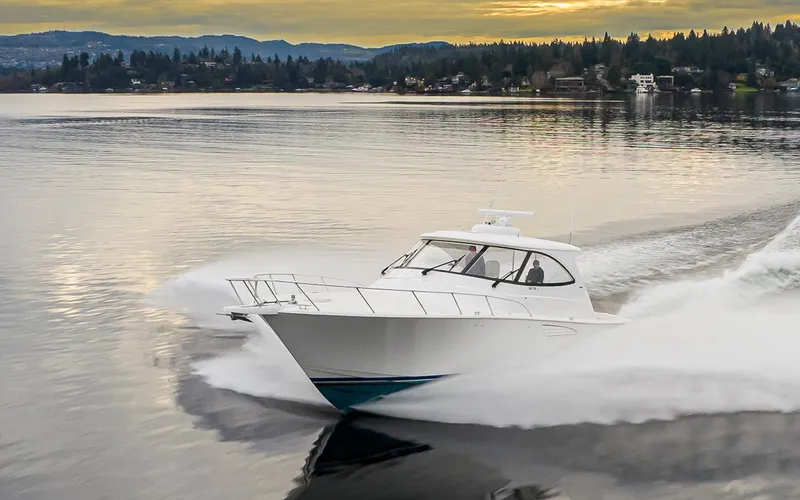 Mixer Yacht Photos Pics 2015 Viking 52 yacht cruising on a serene lake at sunset.