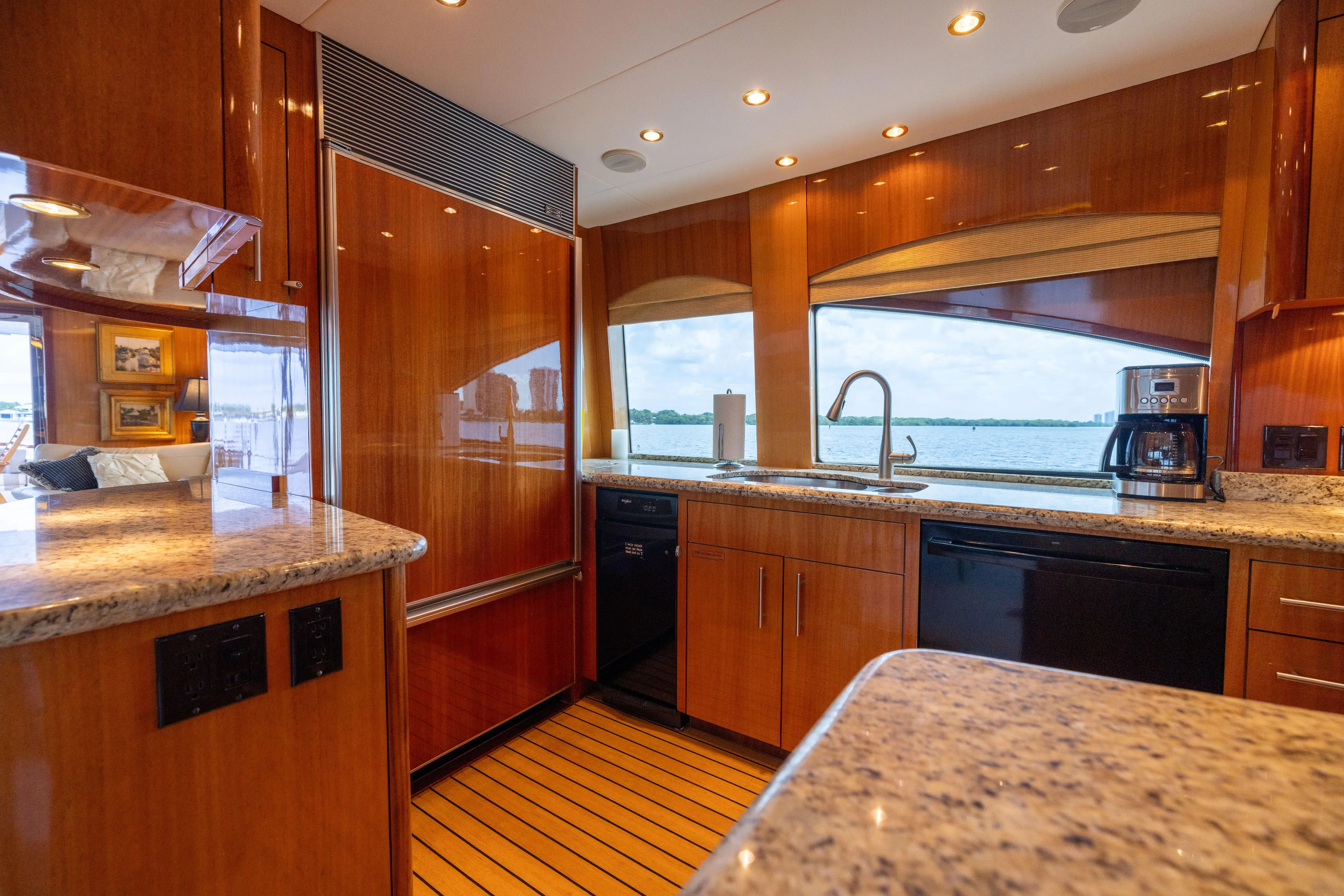Outrageous Yacht Photos Pics Luxurious kitchen interior of 2005 Hatteras 80 Motor Yacht with wood finishes and ocean view.