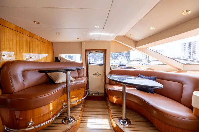 Outrageous Yacht Photos Pics Luxurious interior of 2005 Hatteras 80 Motor Yacht with elegant leather seating and wooden accents.