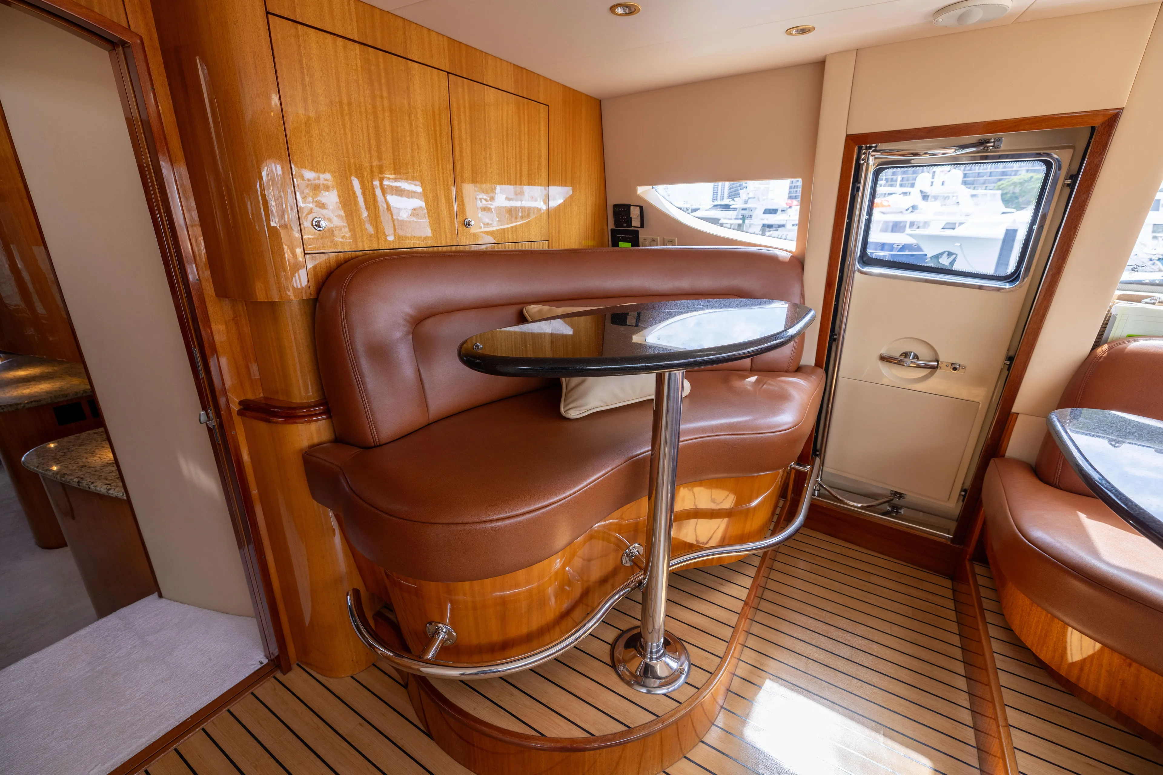 Outrageous Yacht Photos Pics Luxurious interior of 2005 Hatteras 80 Motor Yacht with elegant seating and wooden finishes.