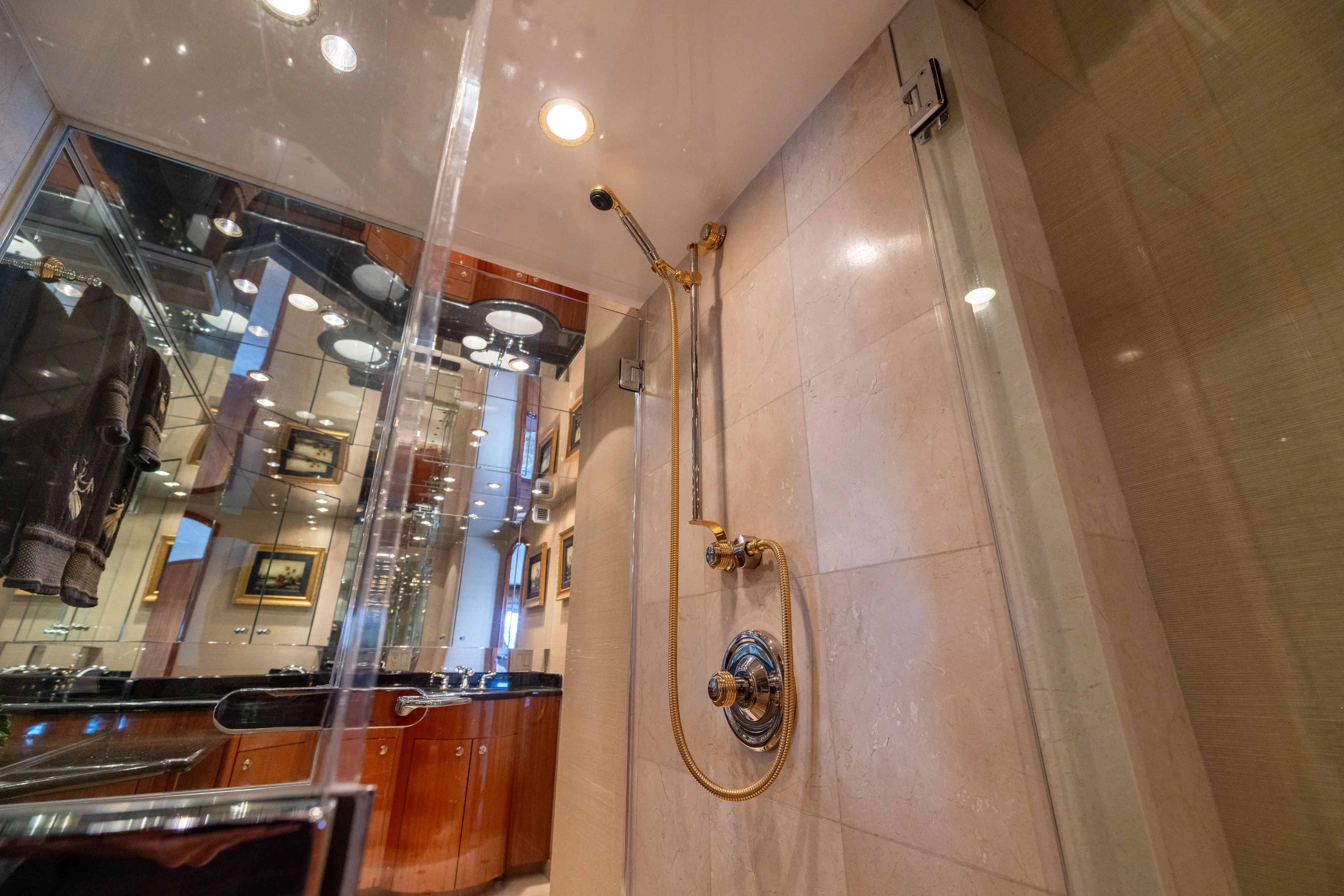 Outrageous Yacht Photos Pics Luxurious bathroom shower in 2005 Hatteras 80 Motor Yacht, featuring elegant fixtures and modern design.