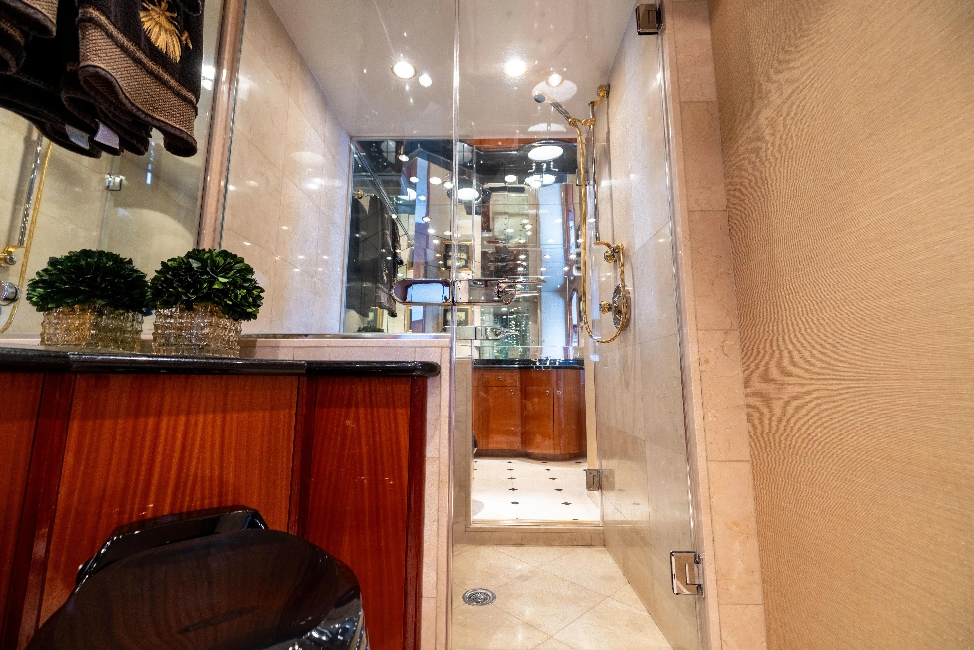 Outrageous Yacht Photos Pics Luxurious bathroom interior on 2005 Hatteras 80 Motor Yacht, featuring elegant wood and glass accents.