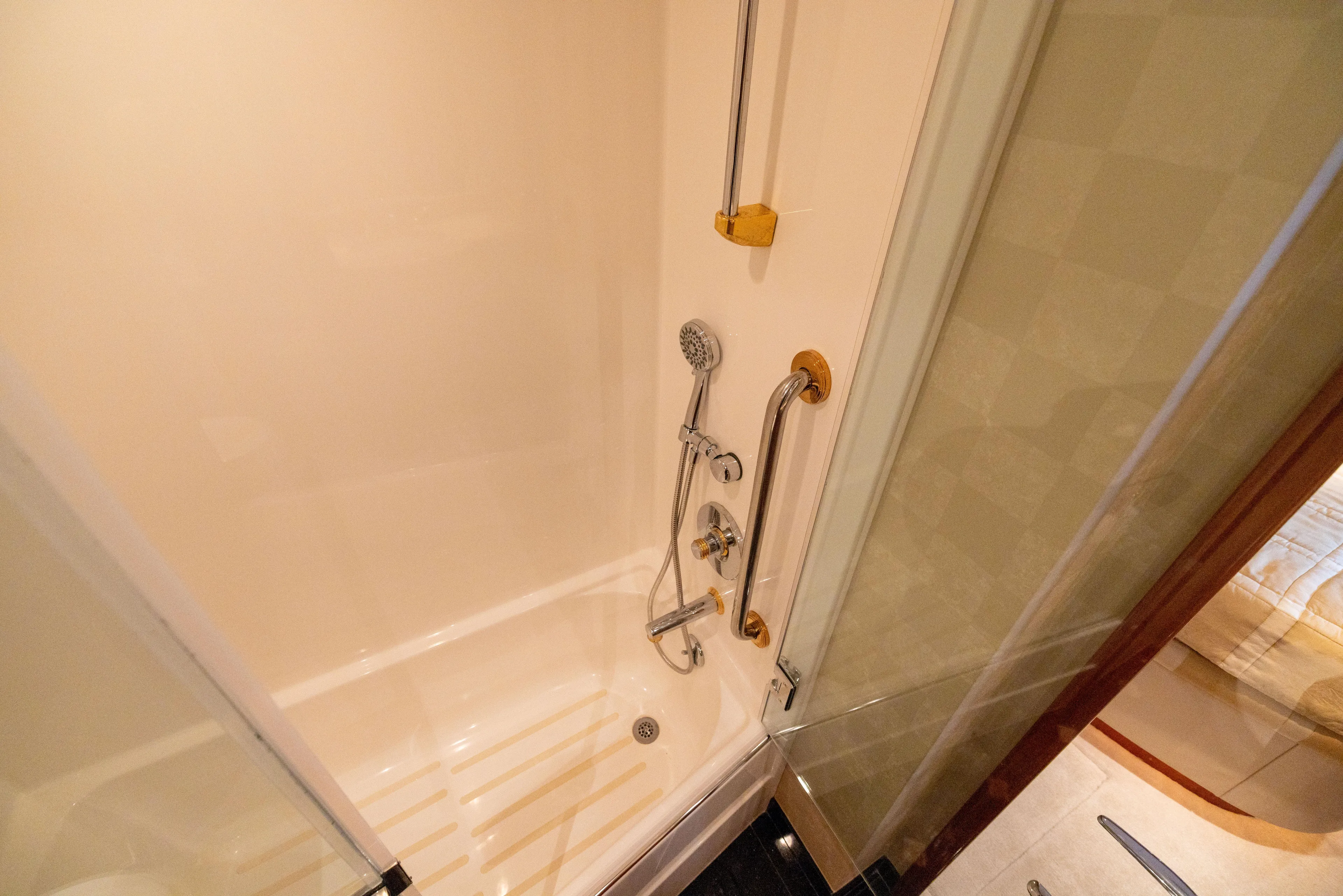 Outrageous Yacht Photos Pics Shower area in 2005 Hatteras 80 Motor Yacht, featuring modern fixtures and glass door.