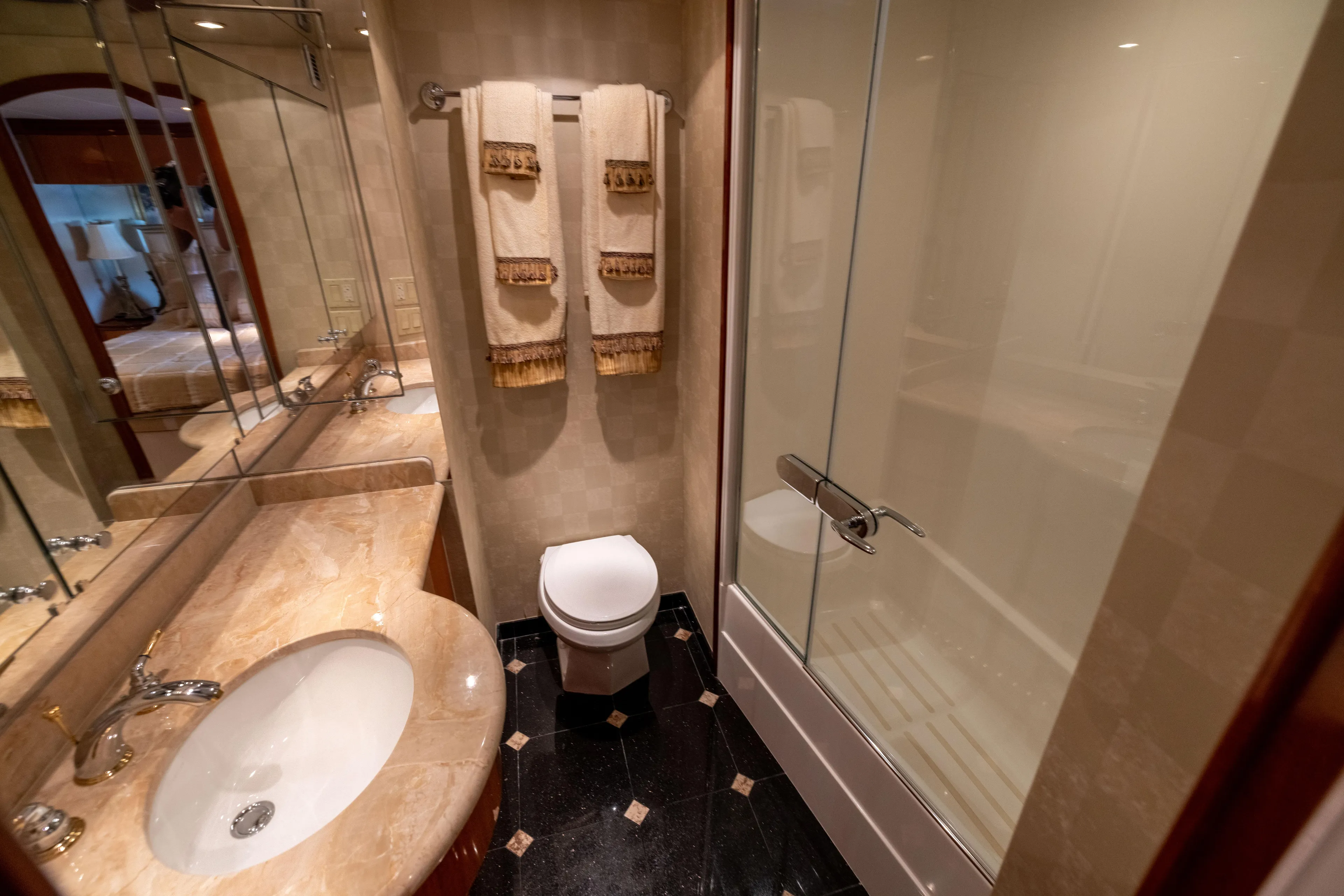 Outrageous Yacht Photos Pics Luxurious bathroom in 2005 Hatteras 80 Motor Yacht with marble sink and glass shower.