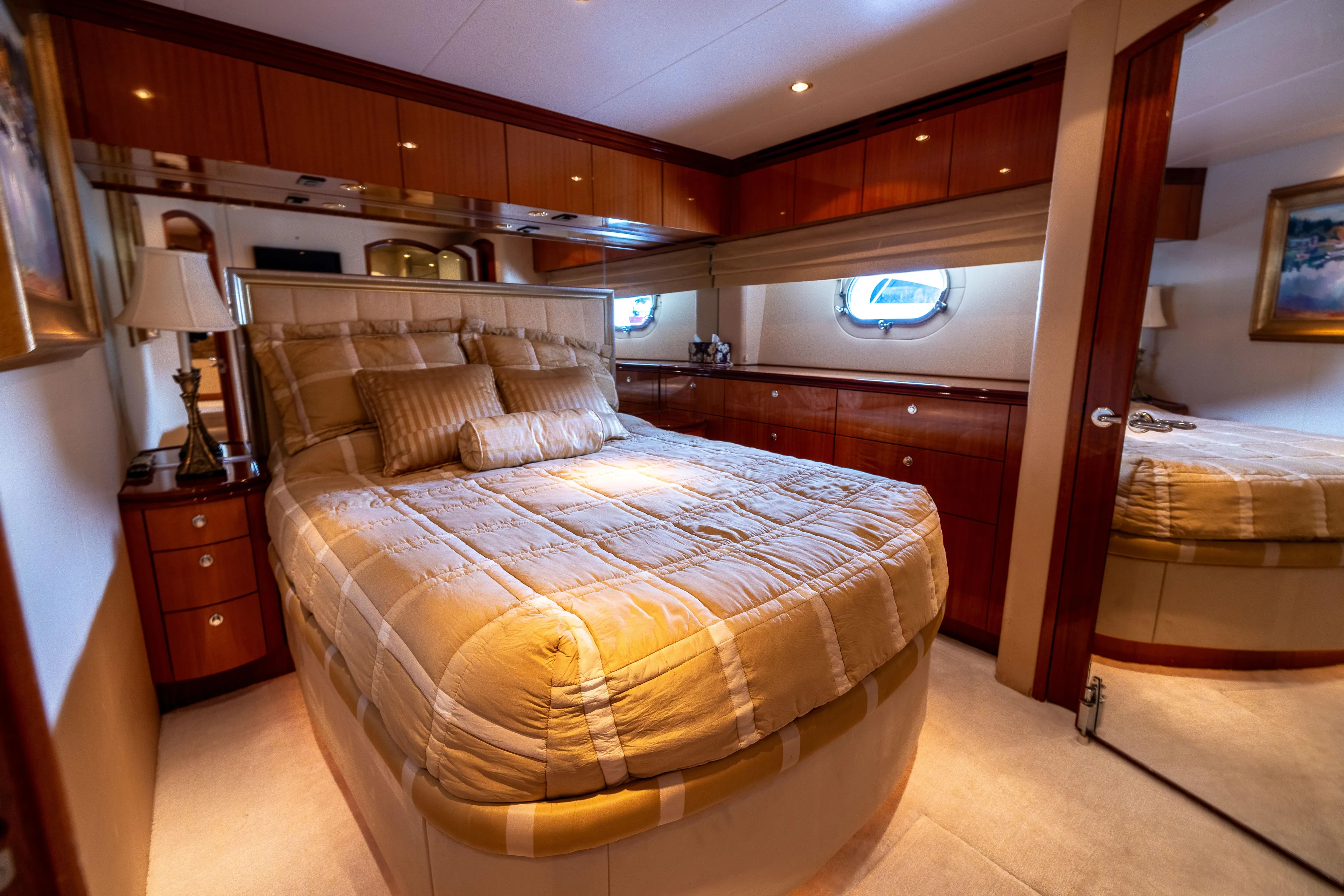 Outrageous Yacht Photos Pics Luxurious bedroom interior of 2005 Hatteras 80 Motor Yacht with elegant wood finishes.