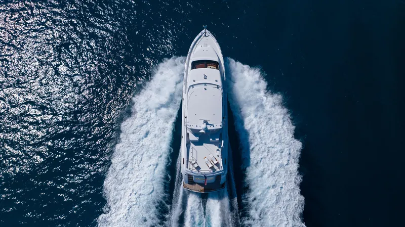 Outrageous Yacht Photos Pics Aerial view of 2005 Hatteras 80 Motor Yacht cruising on open water.