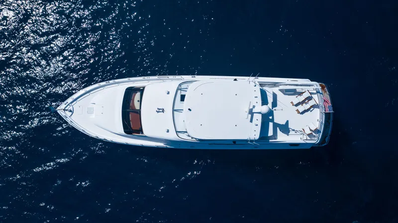 Outrageous Yacht Photos Pics Aerial view of 2005 Hatteras 80 Motor Yacht on blue water.