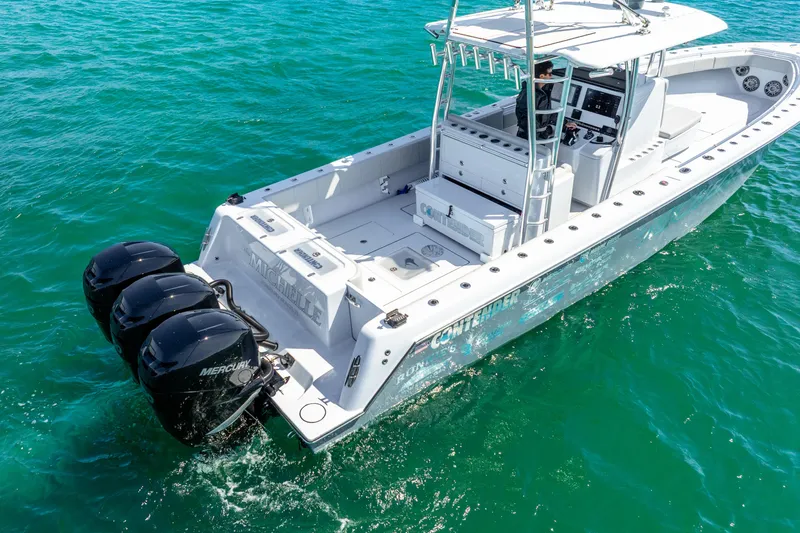  Yacht Photos Pics 2023 Contender 39ST boat with triple Mercury outboard engines on clear blue water.