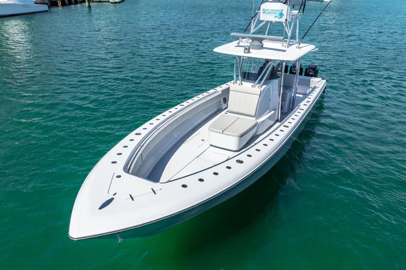  Yacht Photos Pics 2023 Contender 39ST boat on clear blue water, showcasing sleek design and spacious deck.