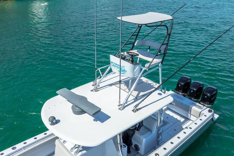  Yacht Photos Pics 2023 Contender 39ST boat with tower and triple engines on clear water.