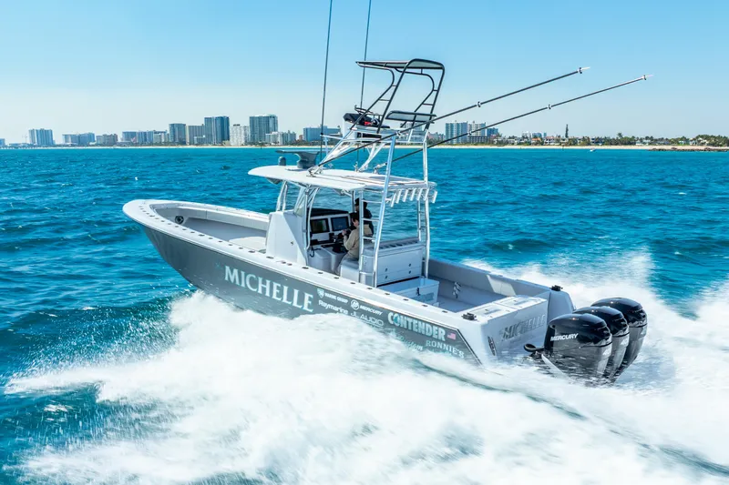  Yacht Photos Pics 2023 Contender 39ST boat cruising on ocean with city skyline in background.