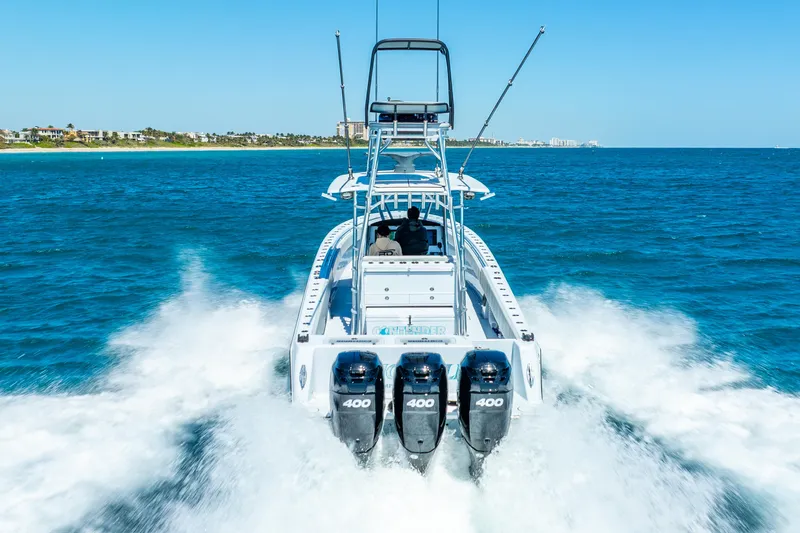  Yacht Photos Pics 2023 Contender 39ST boat with triple 400 engines cruising on open water.