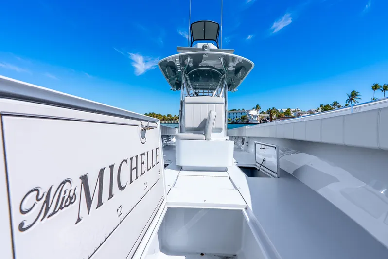  Yacht Photos Pics 2023 Contender 39ST boat "Miss Michelle" under clear blue sky.
