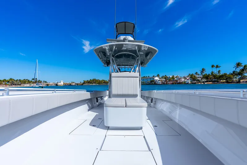  Yacht Photos Pics 2023 Contender 39ST boat on clear blue water with tropical background.