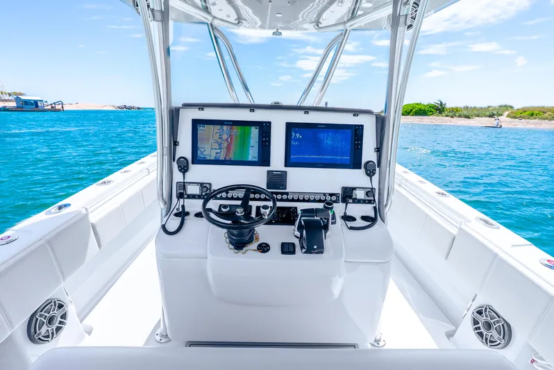  Yacht Photos Pics 2023 Contender 39ST boat dashboard with dual screens on open water.