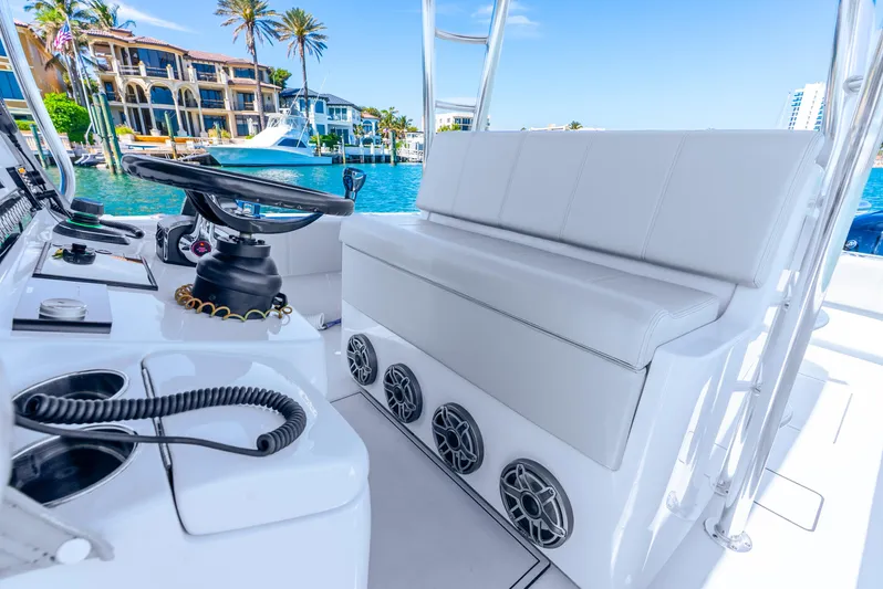  Yacht Photos Pics 2023 Contender 39ST boat interior with white seating and modern controls.