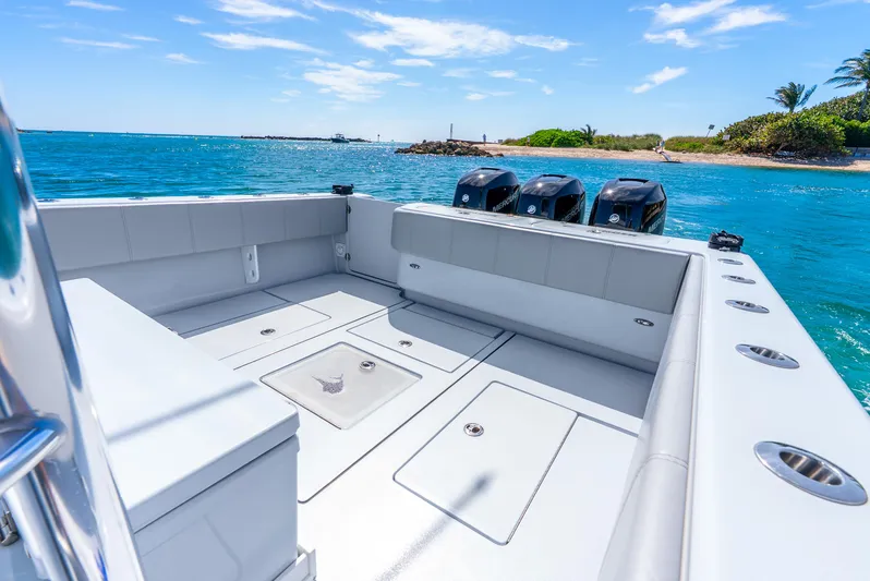  Yacht Photos Pics 2023 Contender 39ST boat with spacious deck and triple engines on a sunny day.