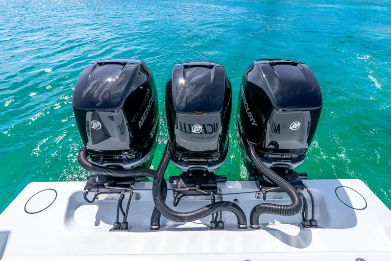  Yacht Photos Pics Triple Mercury outboard engines on a 2023 Contender 39ST boat in clear blue water.